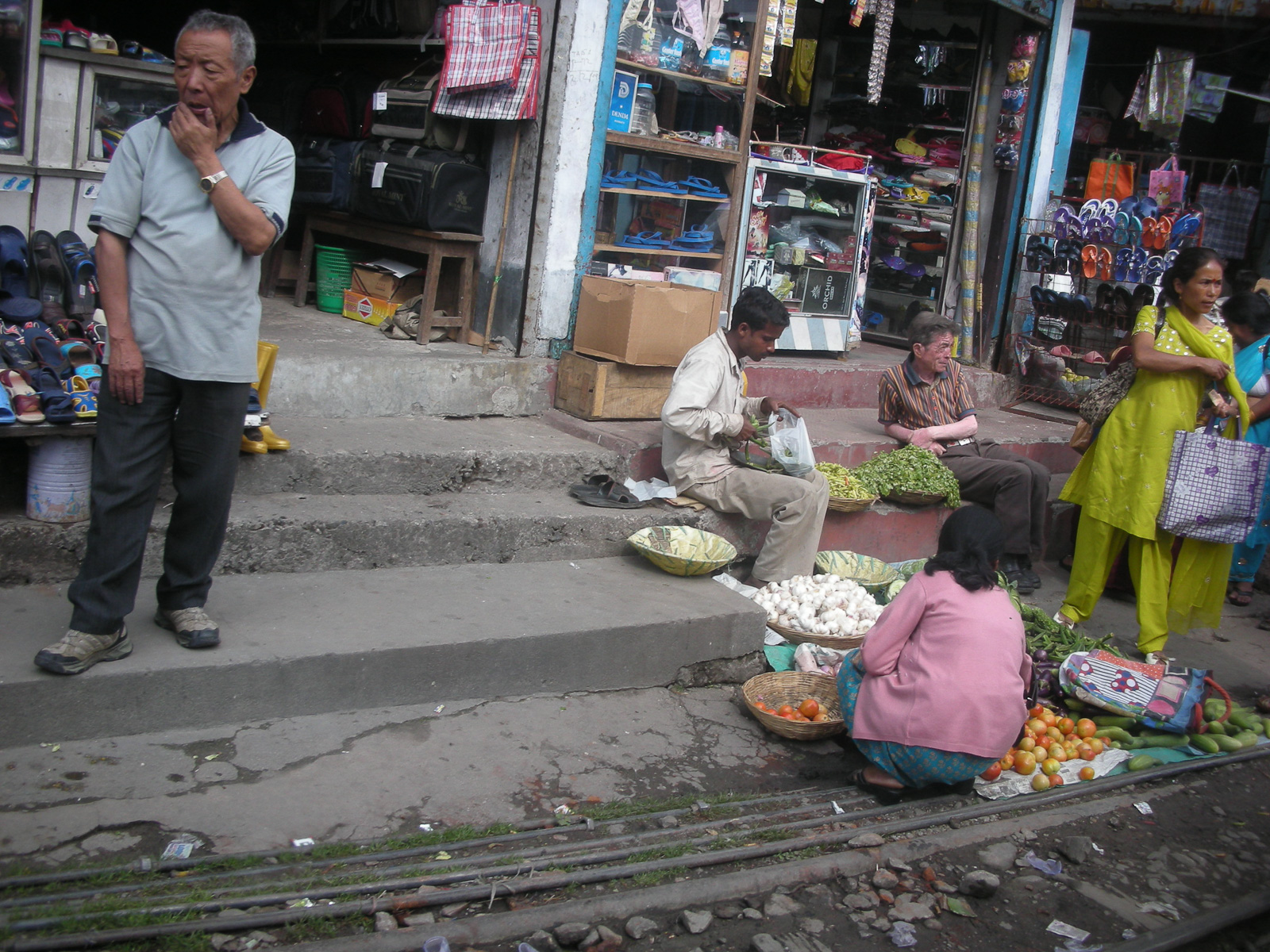Shops on the tracks of the Darjeeling Himalayan Highway, India