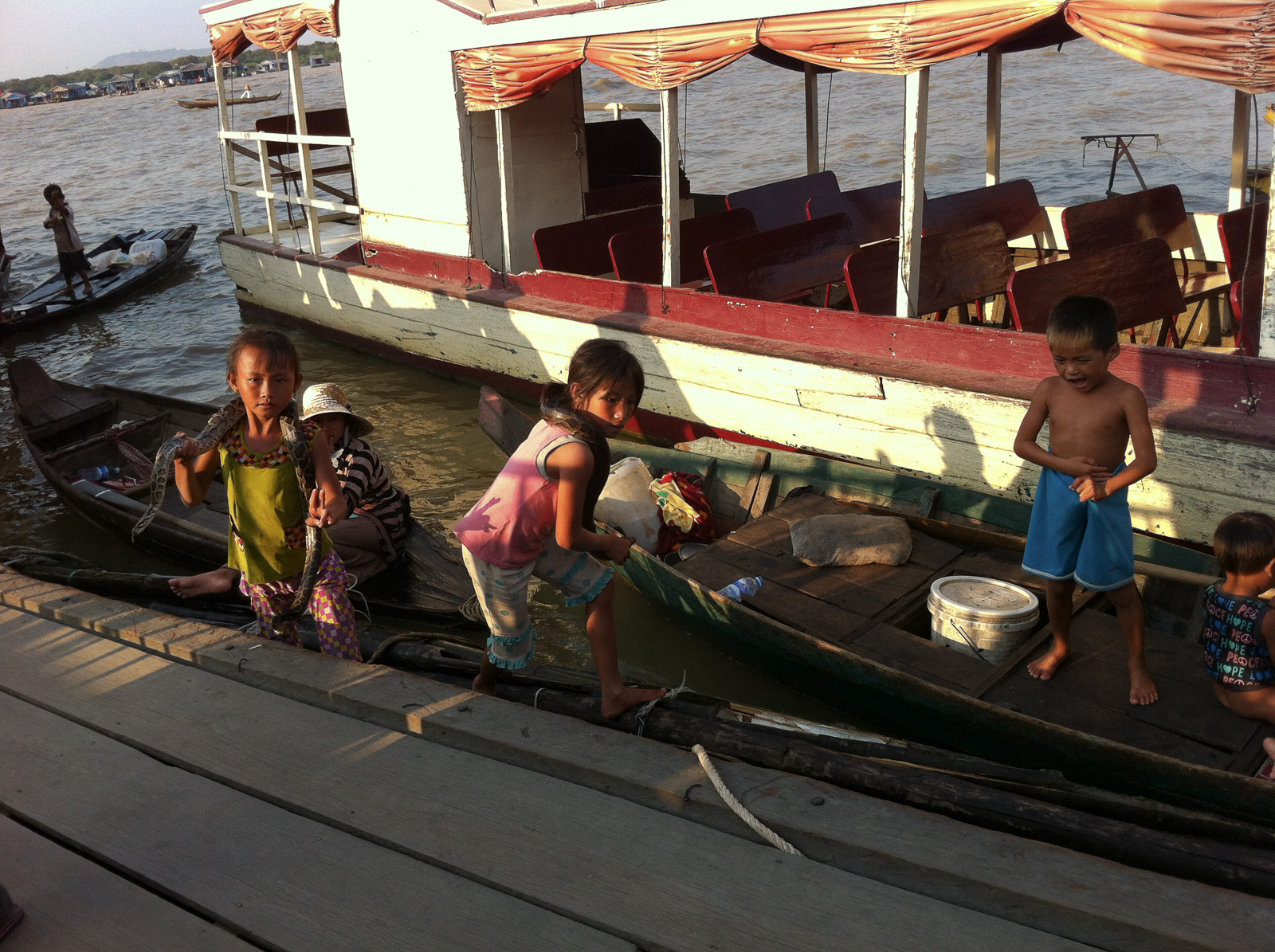 Kids and their snake on Tonle Sap Lake, Cambodia