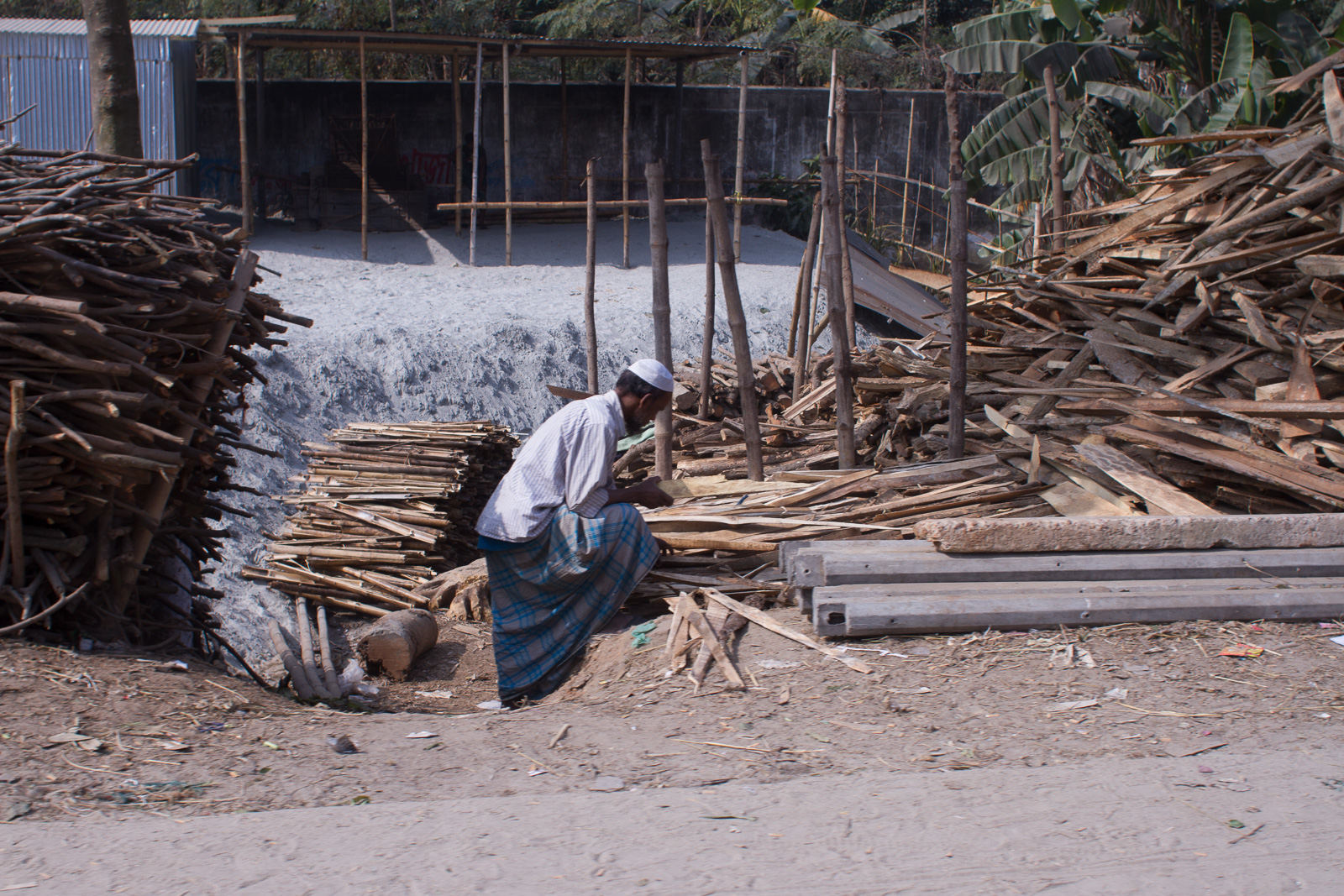 Collecting wood by the road in Bangladesh